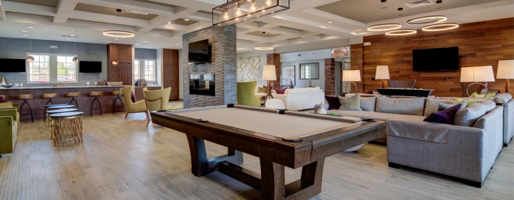 a room with a wood floor and a large wood table