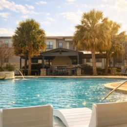 Resort-style swimming pool with lounge seating