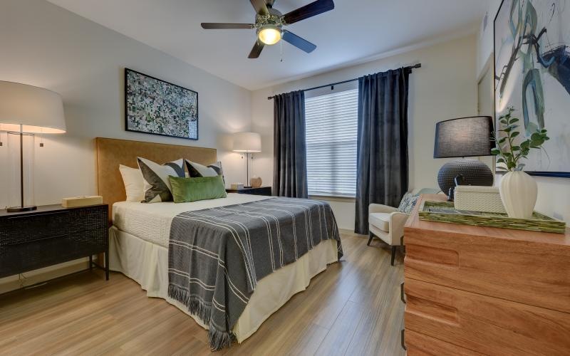 a bedroom with a bed and a desk